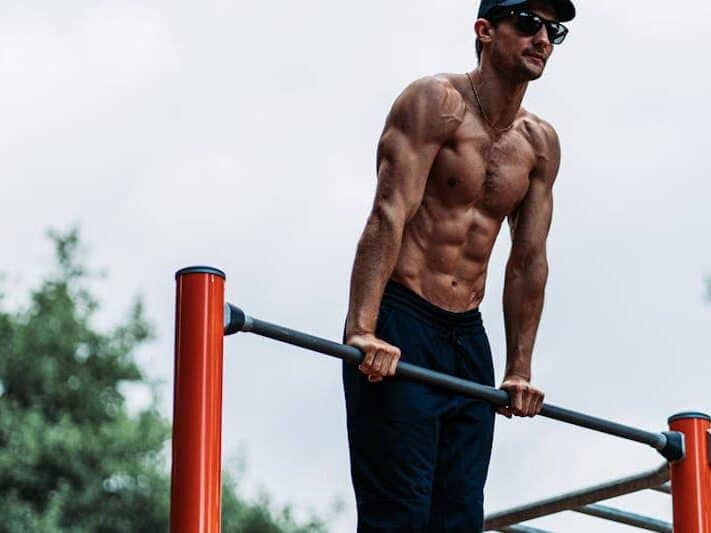 Unlock Calisthenics Strength: 3 Calisthenics Routines 14 man doing a muscle-up